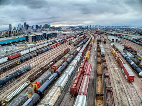 Vue aérienne d'un terminal ferroviaire avec de nombreux wagons, symbolisant la gestion du transport efficace.